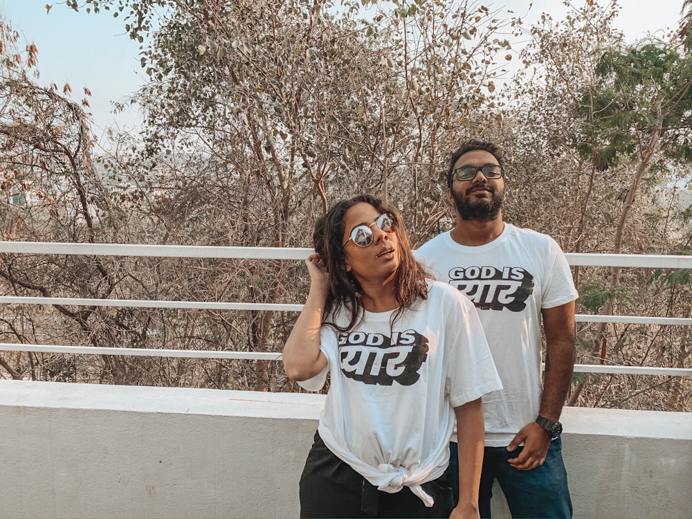 man in white crew neck t-shirt standing beside woman in white crew neck t-shirt