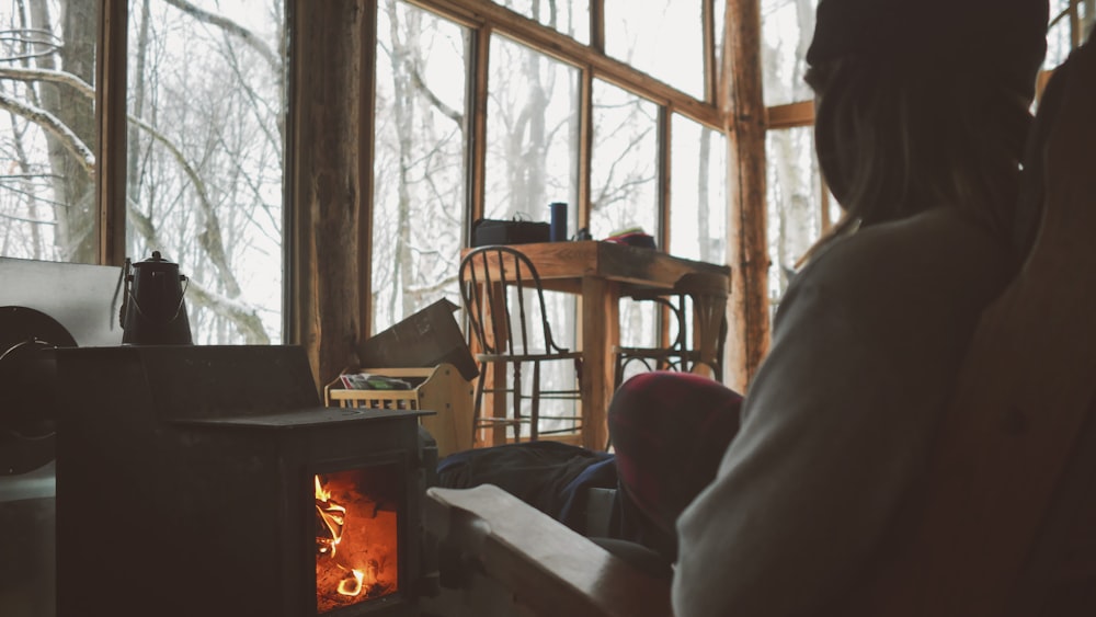 black fireplace near brown wooden chair