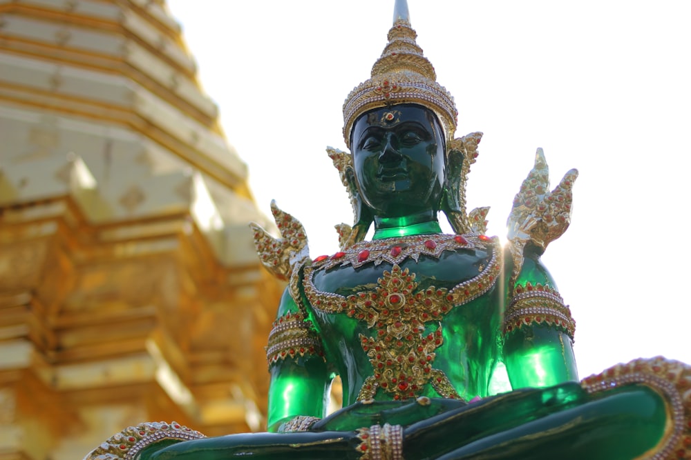 gold and green hindu deity statue