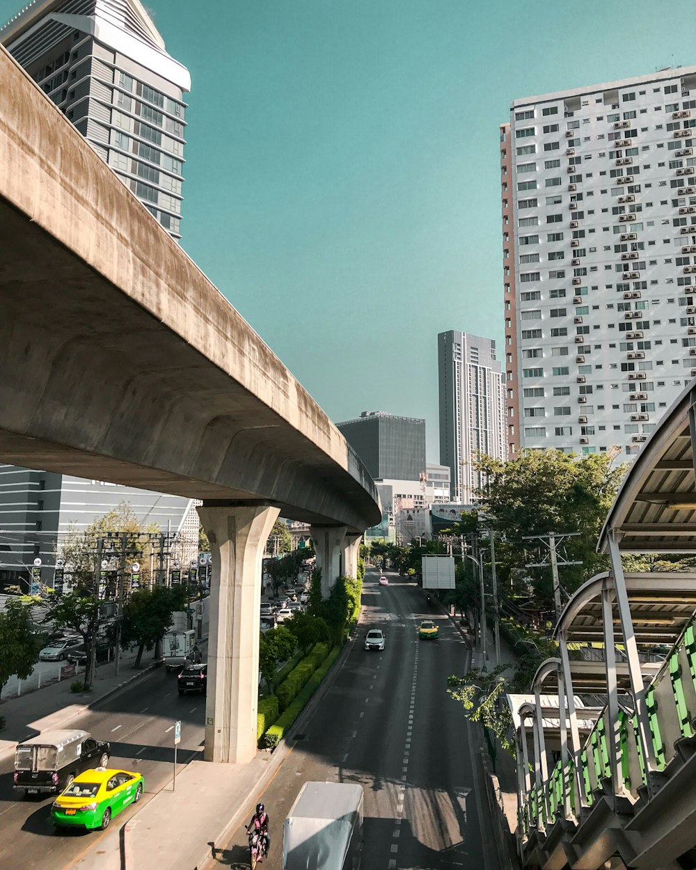 cars on road near white concrete building during daytime