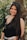woman in black tank top standing beside green plant