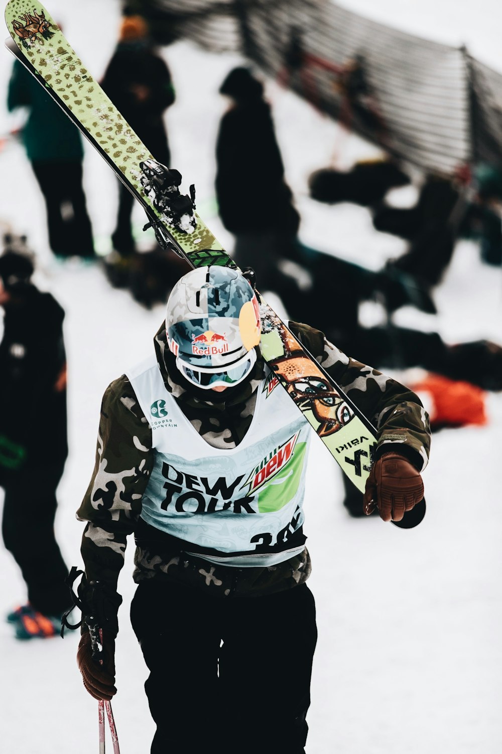 person in white and green jacket and black pants riding on ski blades