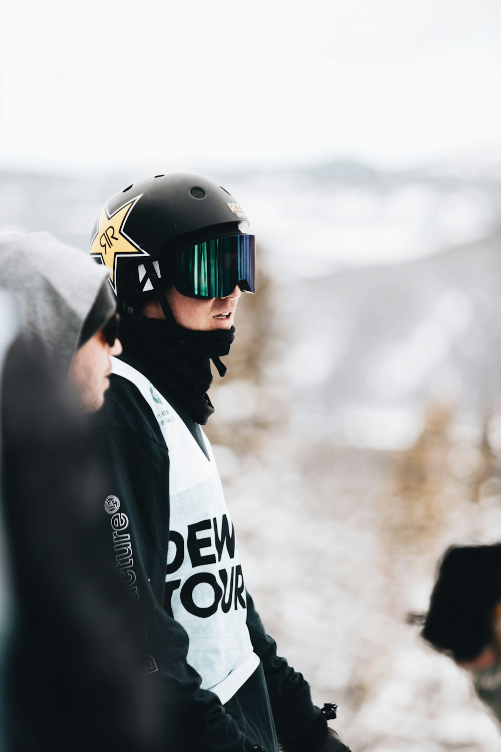 man in black helmet and white and black adidas jacket