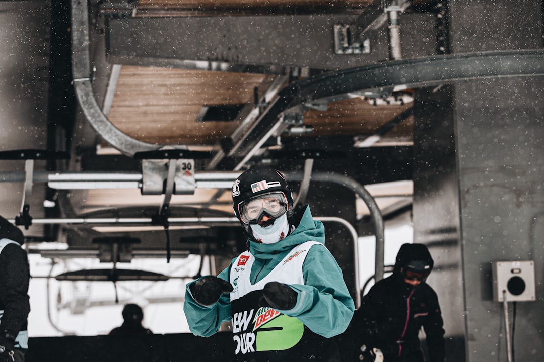 man in black jacket wearing white goggles