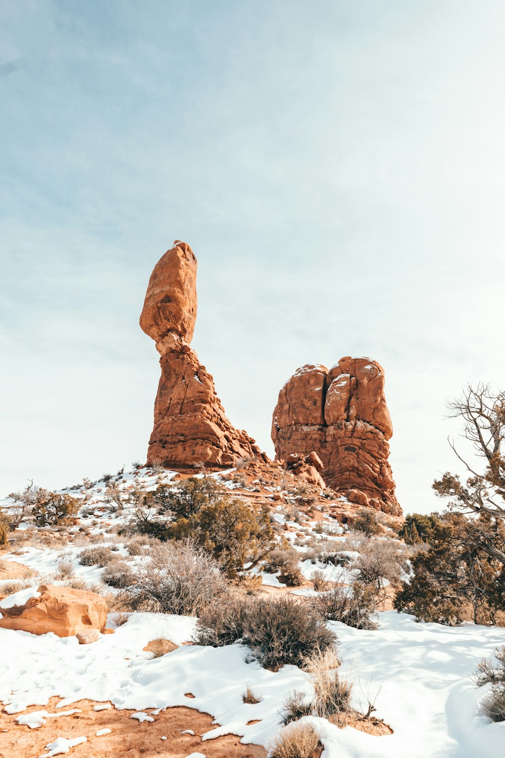 brown rock formation under white clouds during daytime