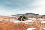 Close-up of a bulldozer pushing earth on a dusty mining field.