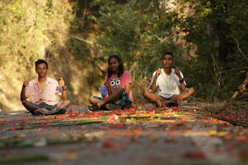 Young people praying together joyfully in a sunlit spring garden