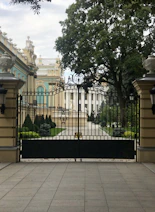 a large gate with a clock on top of it