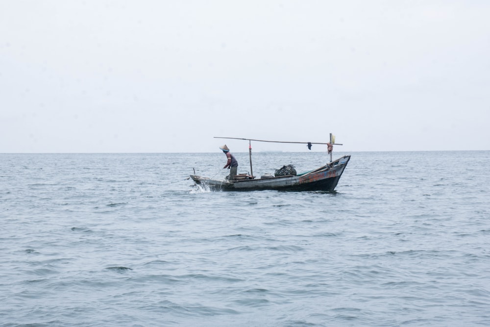 black and red boat on sea during daytime