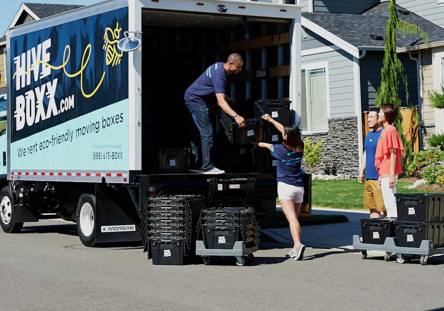 Couple packing their belongings into moving boxes at home