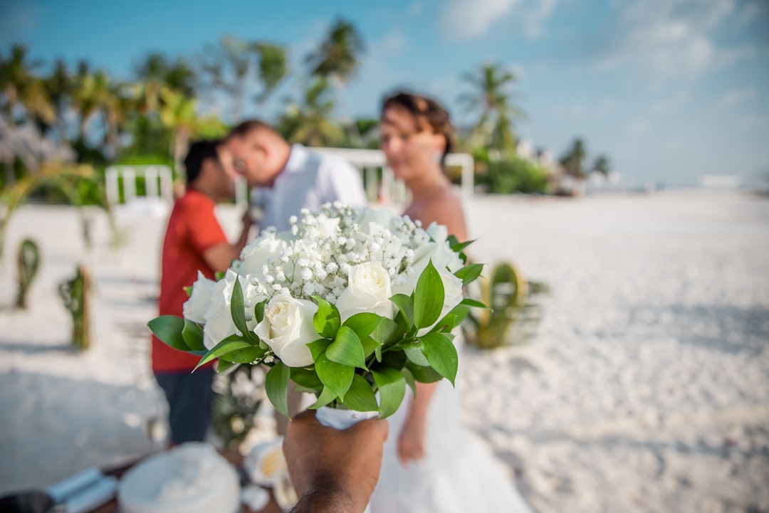 woman in white wedding dress holding bouquet of white flowers