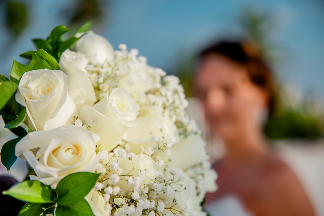 white rose bouquet in front of man
