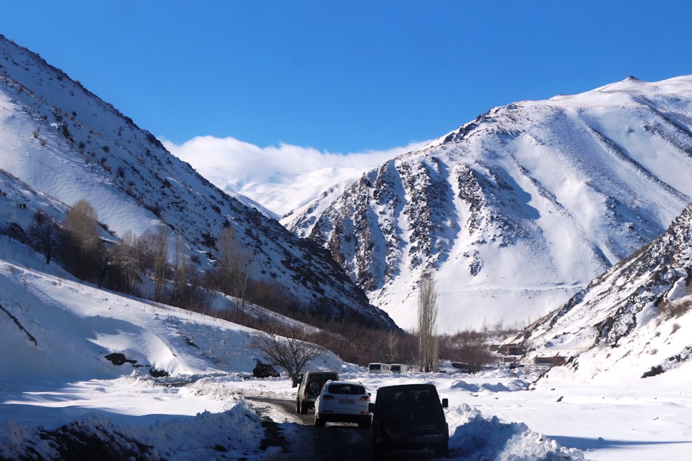 black car on snow covered ground during daytime