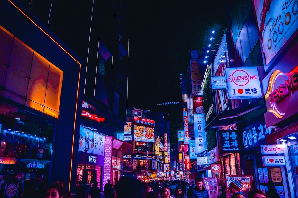 people walking on street during nighttime