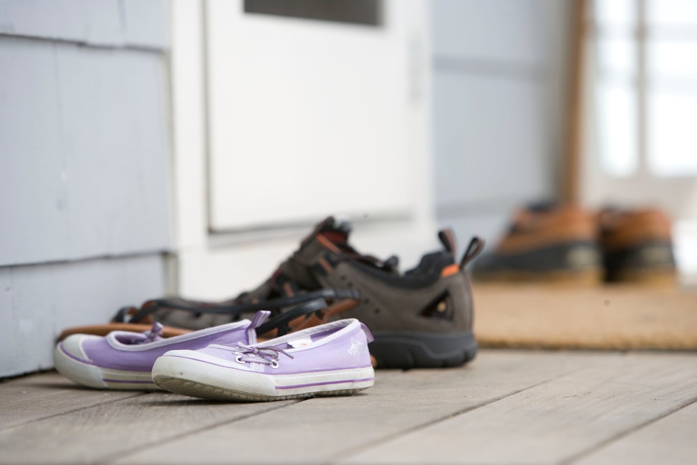 a pair of shoes sitting on the ground next to a door