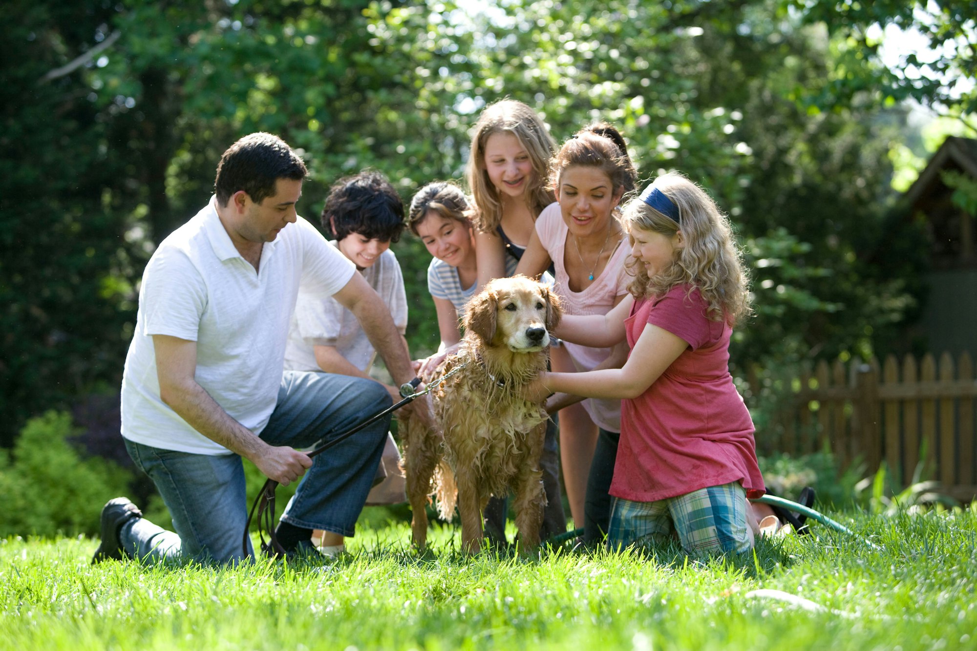 A big family giving a dog a bath