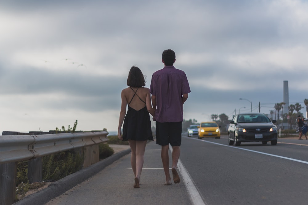 man in purple dress shirt standing beside woman in brown dress