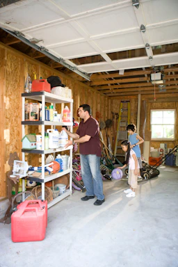 A friendly professional from Refined Garage discussing renovation plans with a homeowner in a bright, organized garage space.