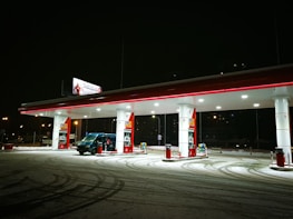 A roadside assistance van providing tire and fuel service at night.