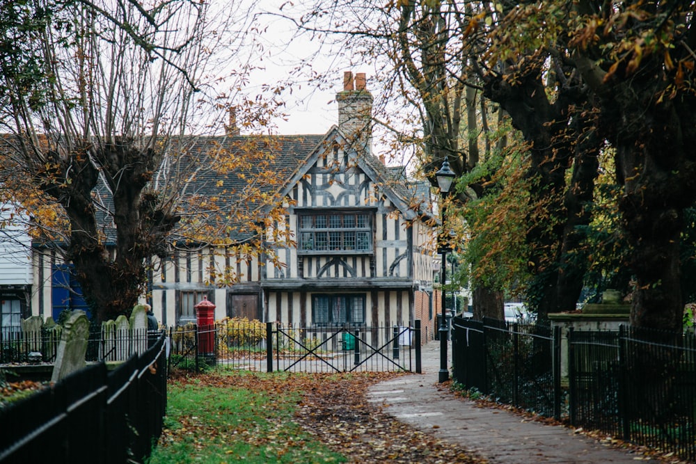 white and brown wooden house near trees during daytime