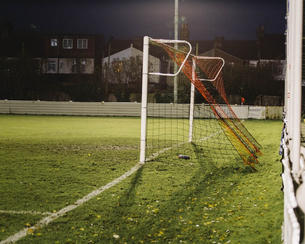 white metal soccer goal net on green grass field
