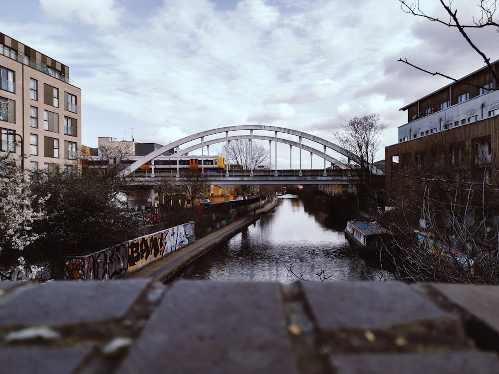 bridge over river near building during daytime