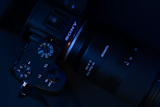 black dslr camera on white textile