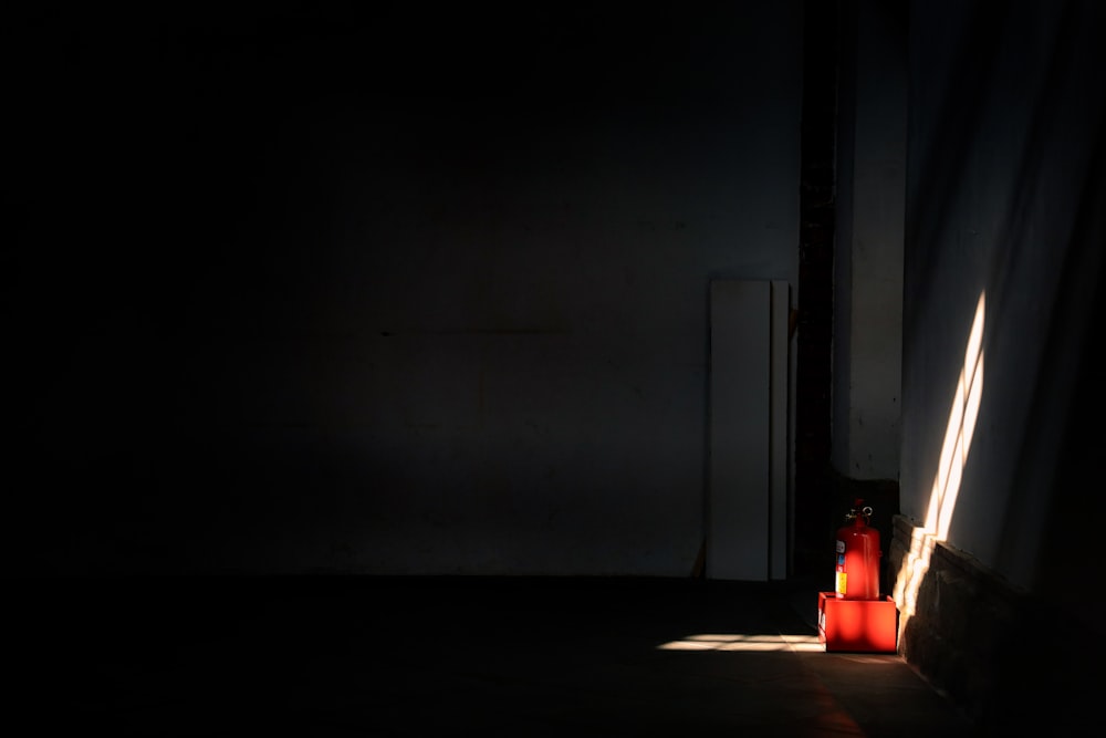 red lighted candle on brown wooden table