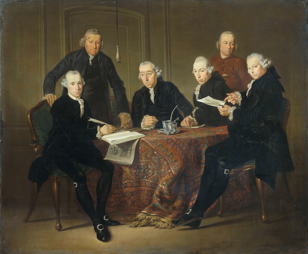 group of people sitting on brown wooden chair