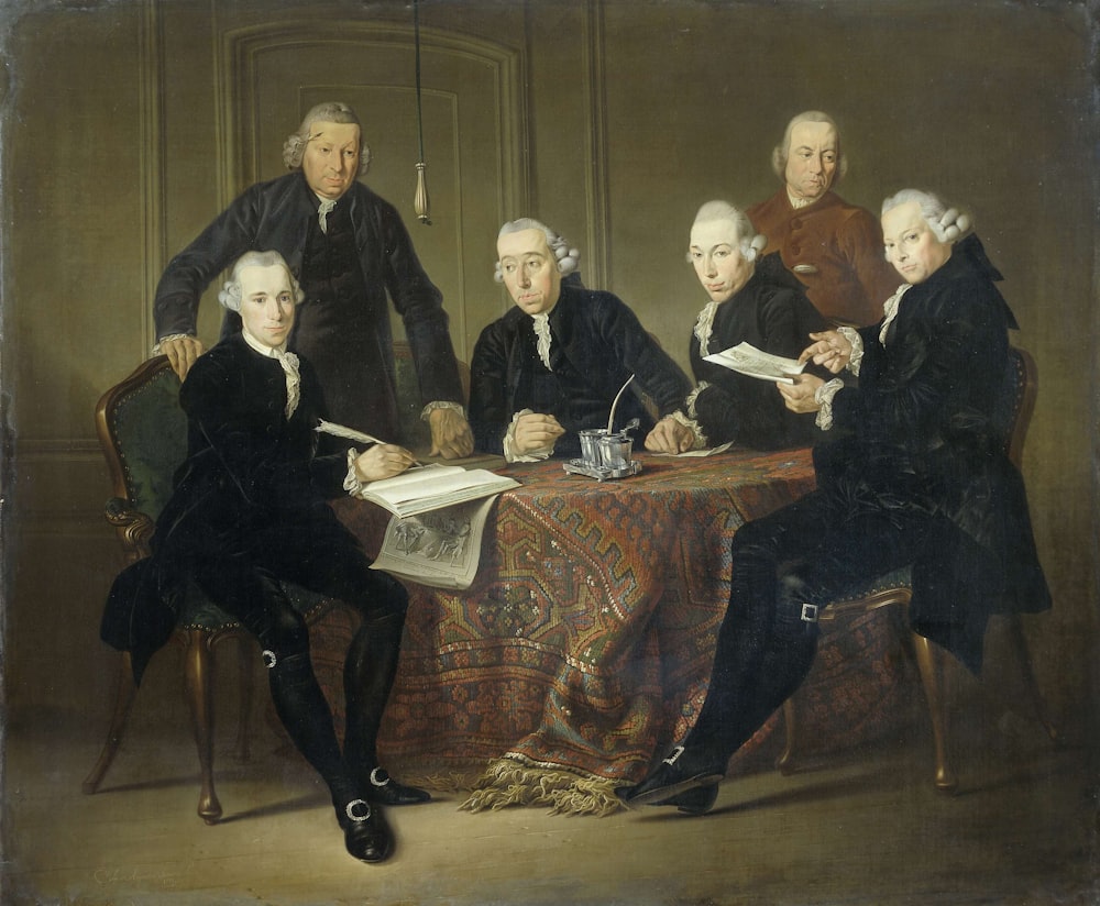 group of people sitting on brown wooden chair