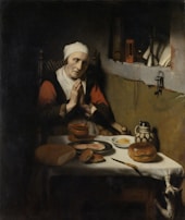 A family holding hands in prayer before a meal.