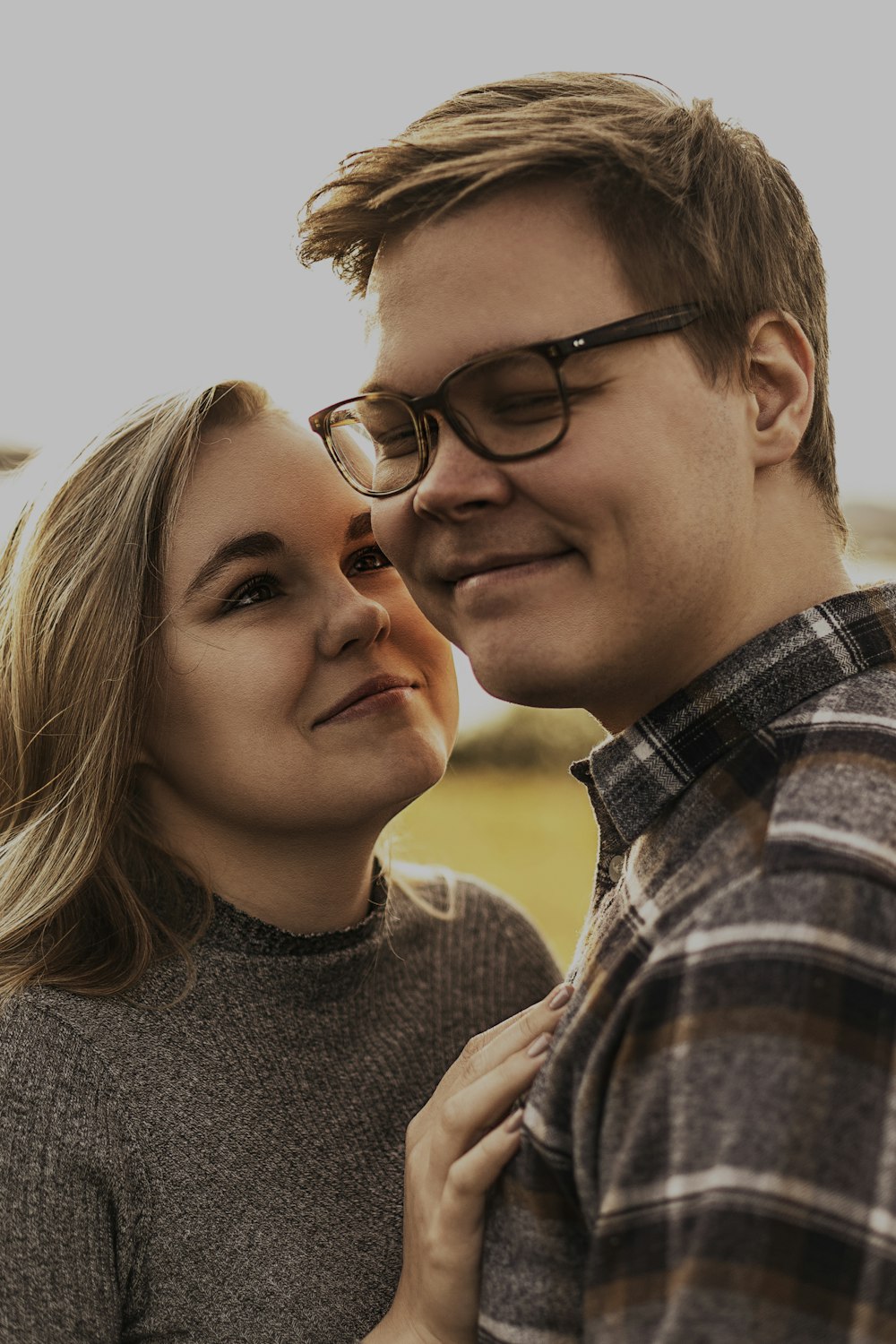 man in grey crew neck shirt wearing eyeglasses smiling