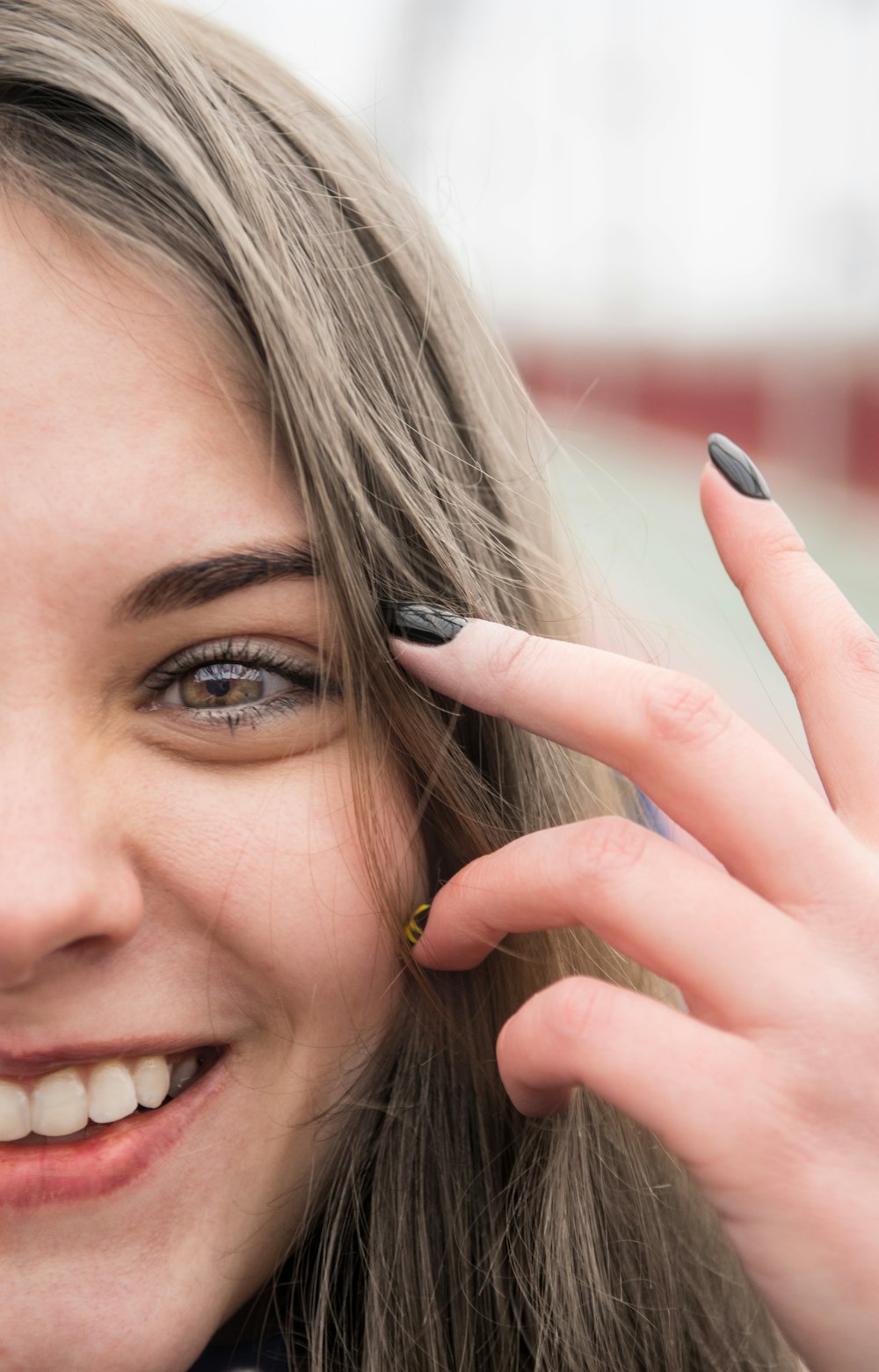 woman with black hair and wearing gold ring