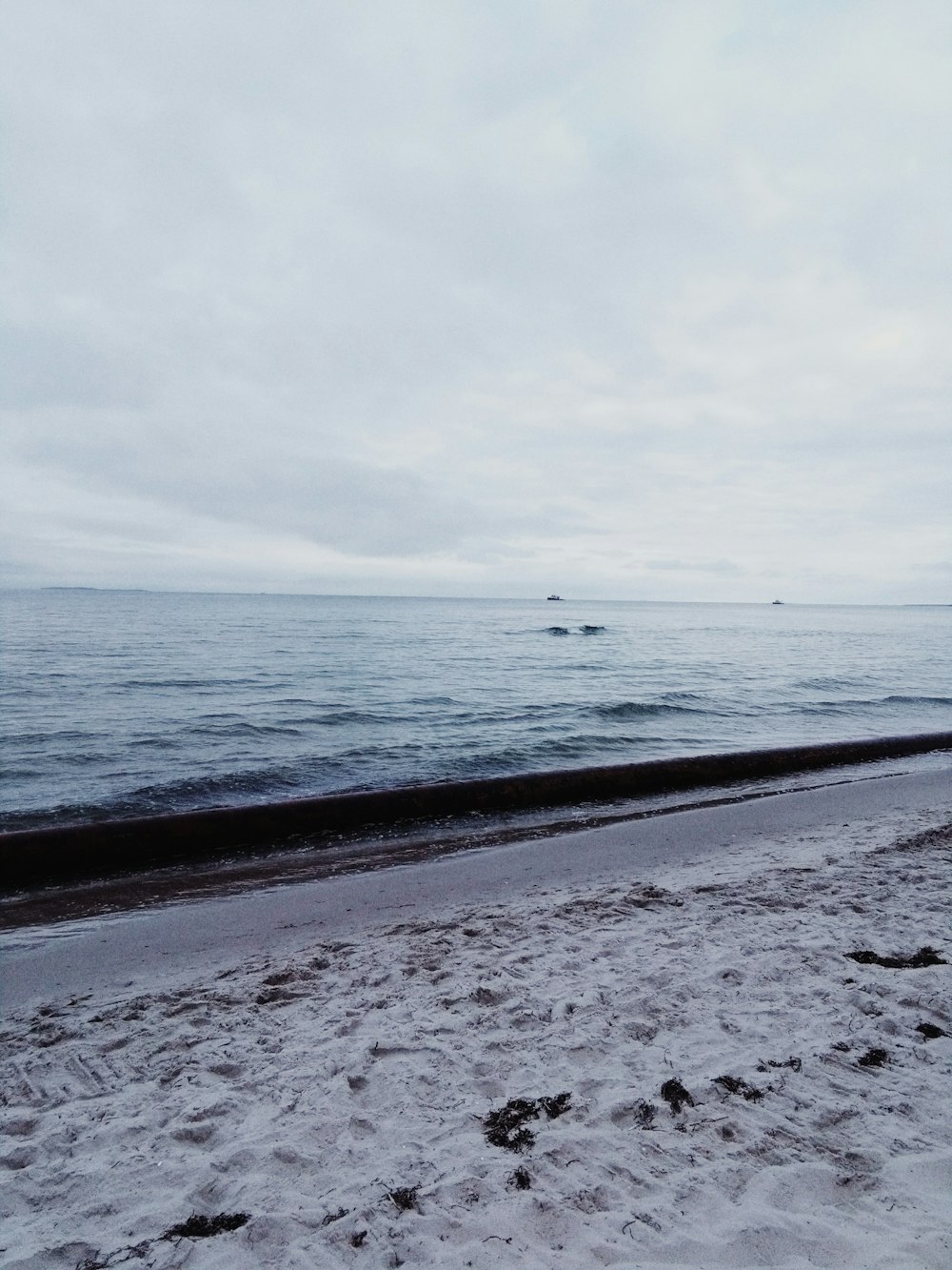 body of water under white sky during daytime