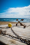 brown wooden cross on brown wooden dock during daytime