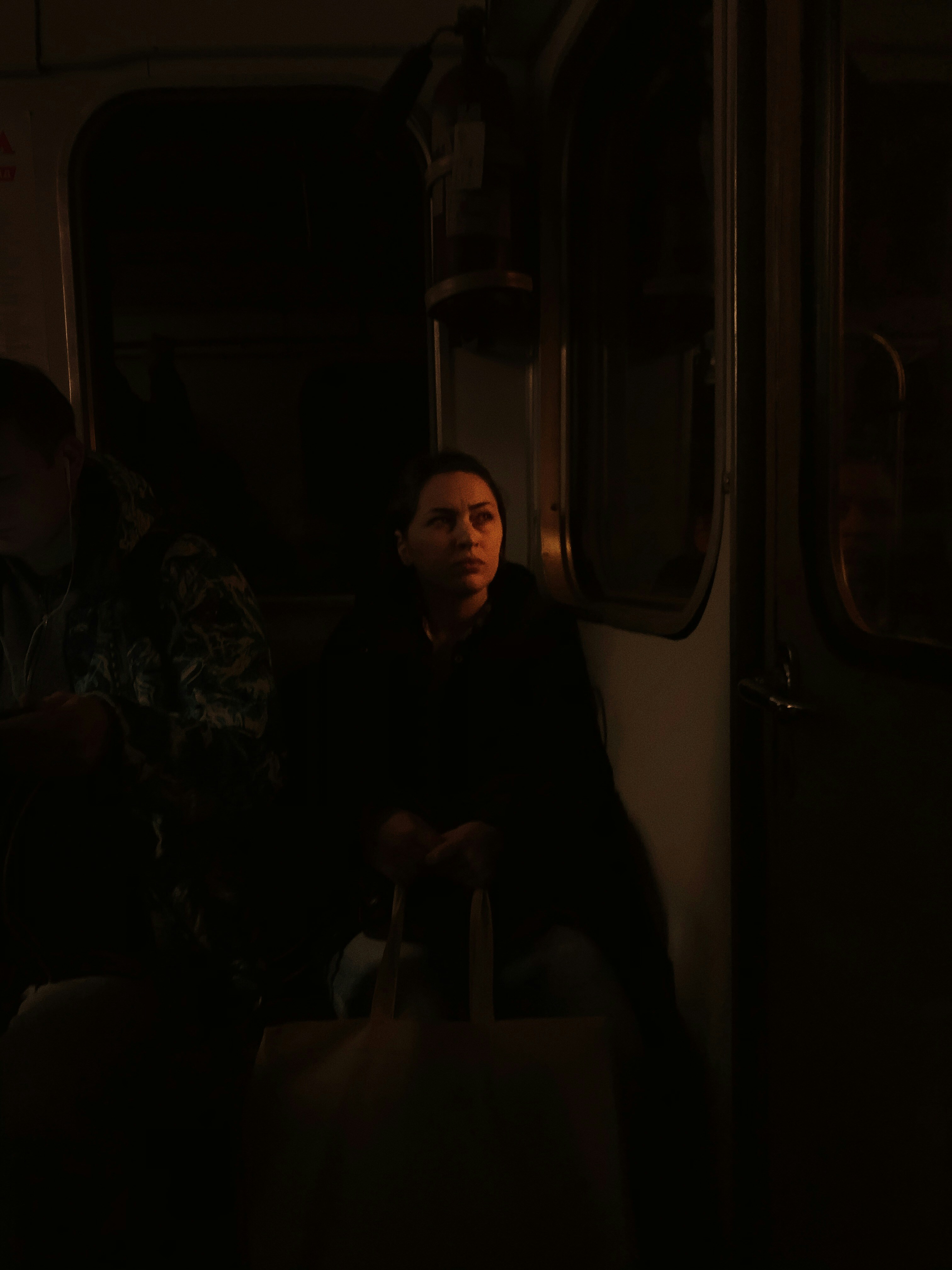 man in black jacket sitting on chair