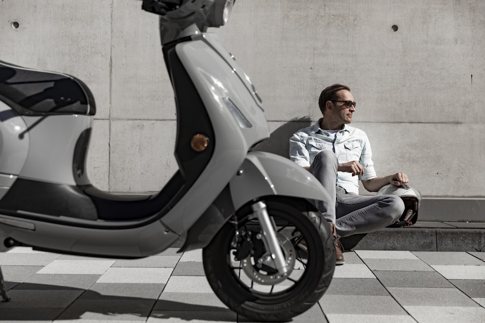 man in white dress shirt sitting on black motorcycle