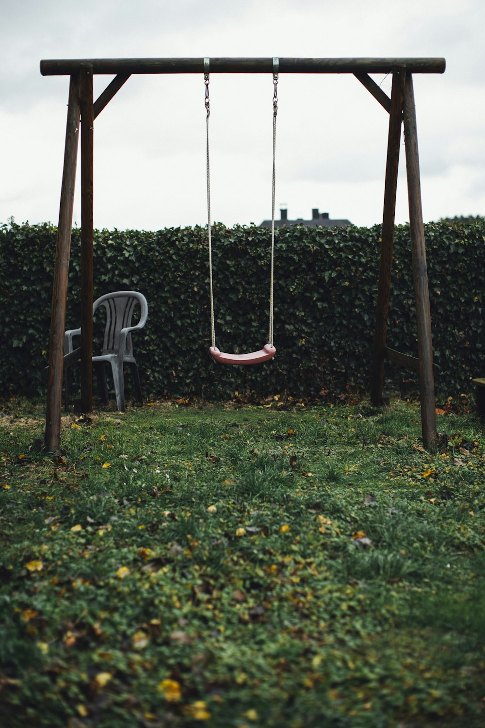 brown wooden swing on green grass field