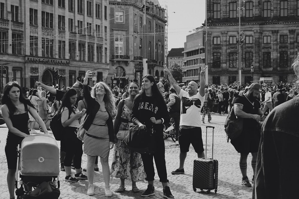 grayscale photo of people standing on street