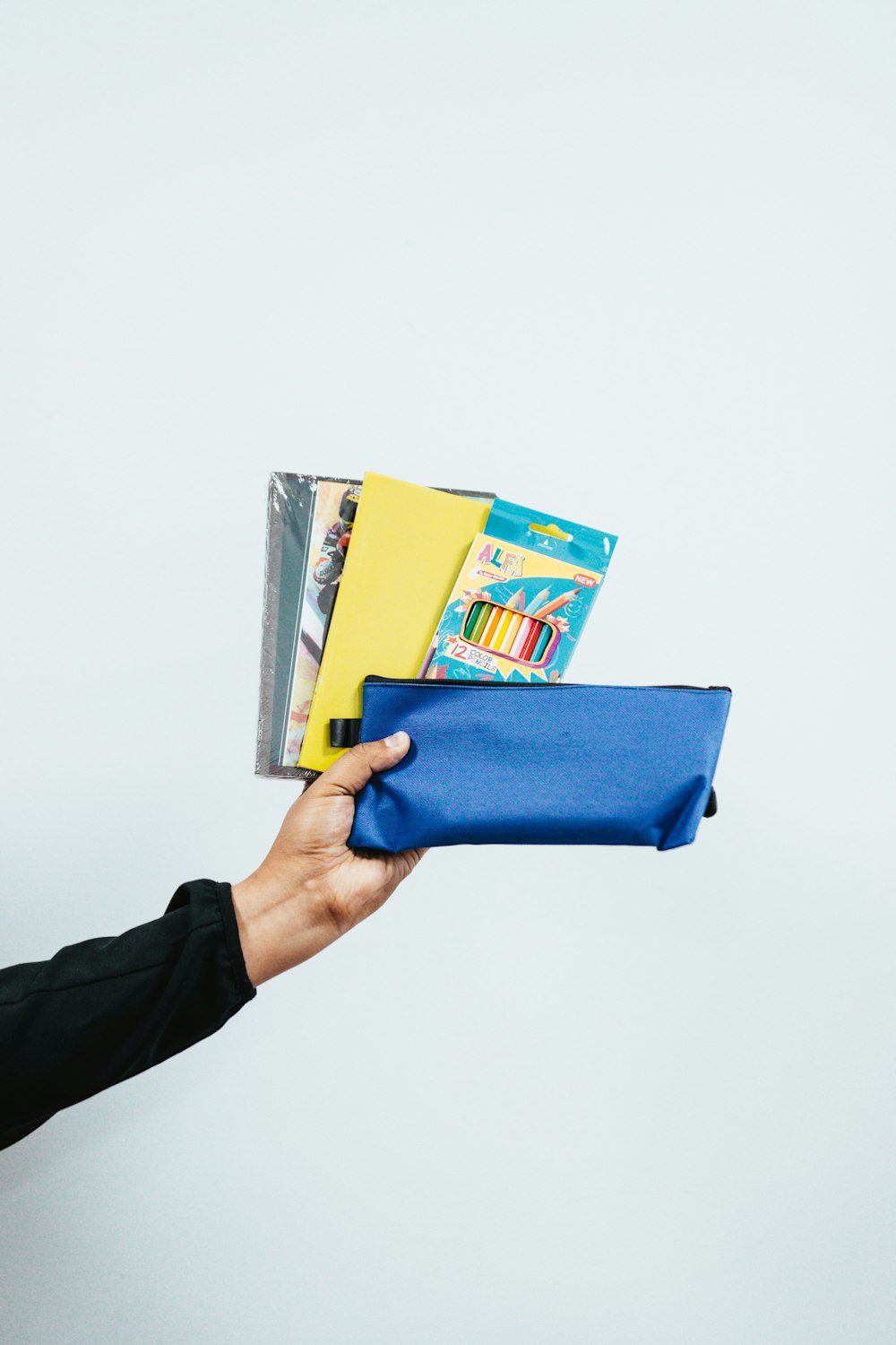 person holding blue leather tablet case