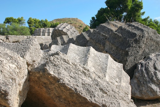 Granite blocks displayed outdoors with a backdrop of a construction site.