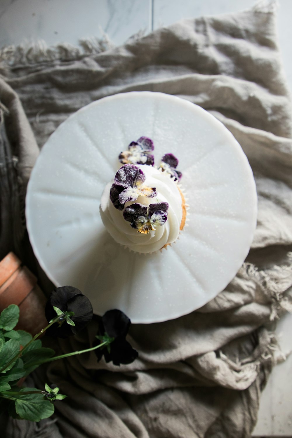 white and purple flower on white round plate