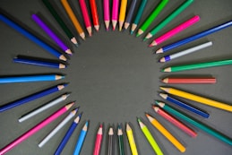 multi colored pencils on black surface