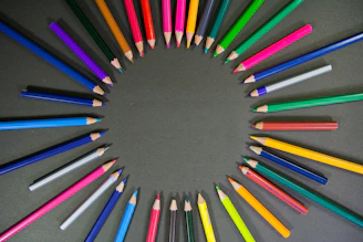 multi colored pencils on black surface