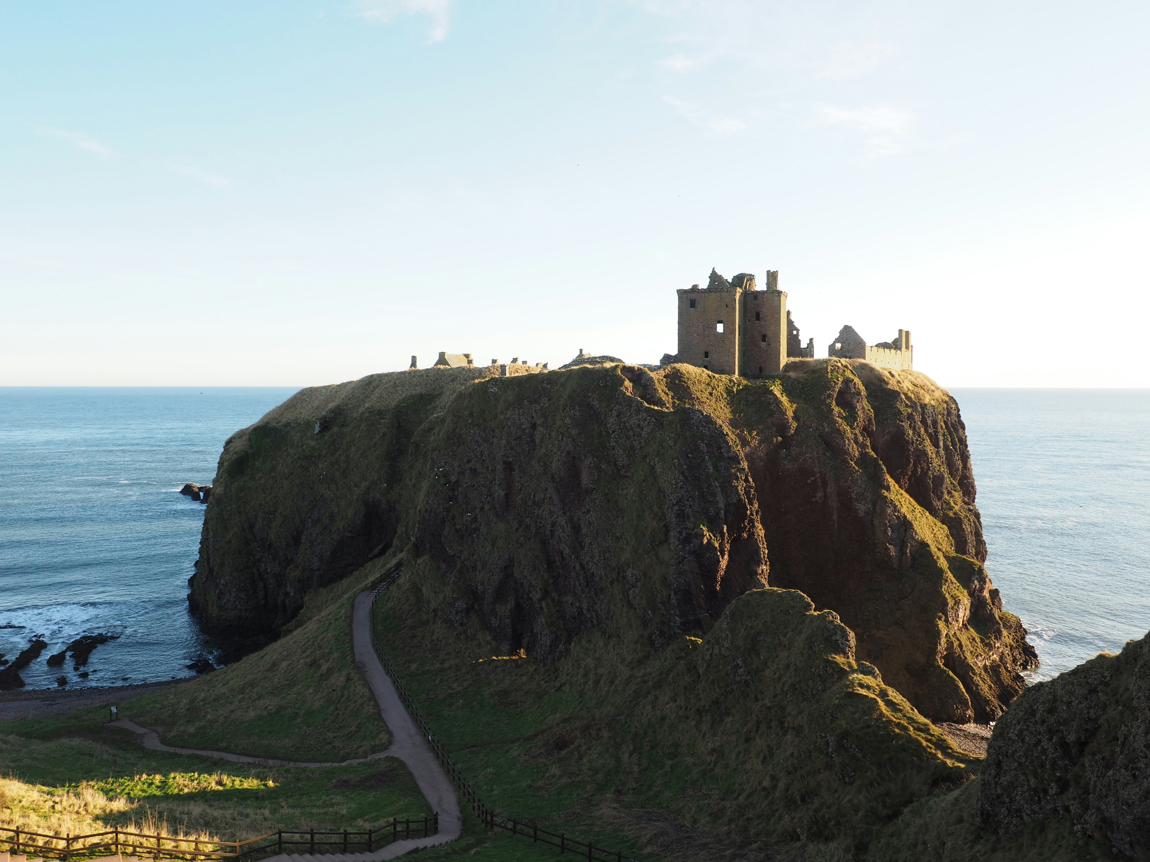 brown concrete castle on cliff by the sea