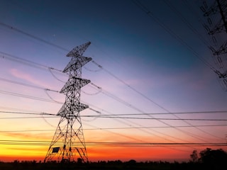 black electric tower under blue sky during sunset