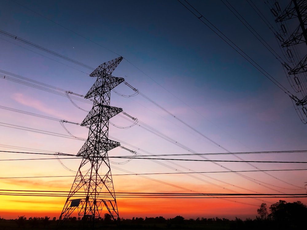 black electric tower under blue sky during sunset