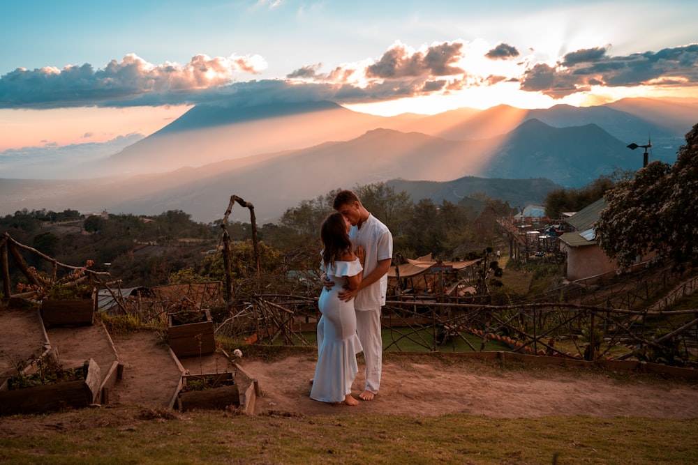 man and woman standing on brown soil during daytime