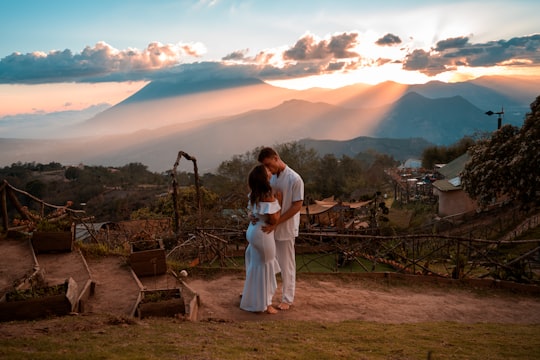 man and woman standing on brown soil during daytime in Antigua Guatemala Guatemala