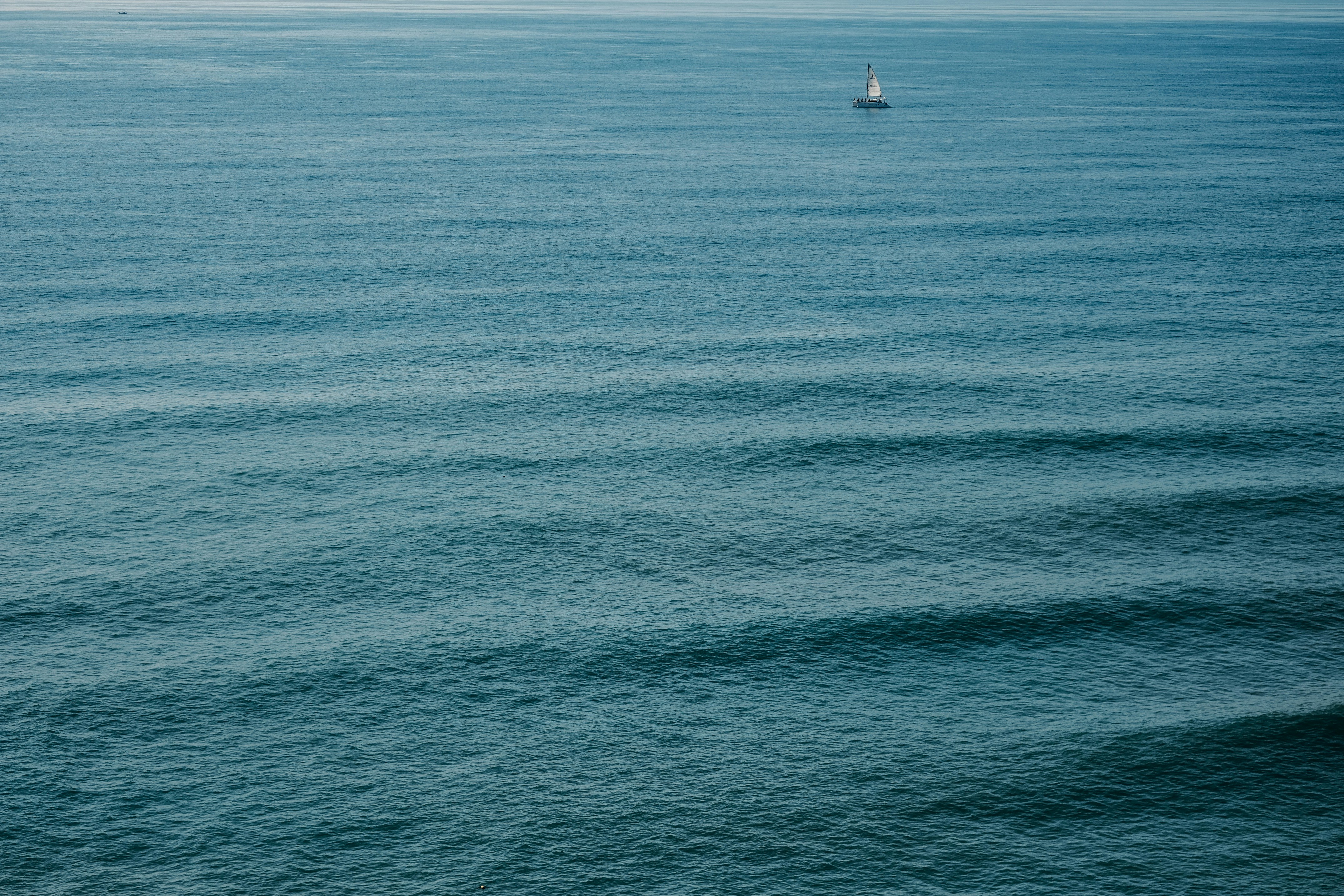 white sailboat on blue sea during daytime